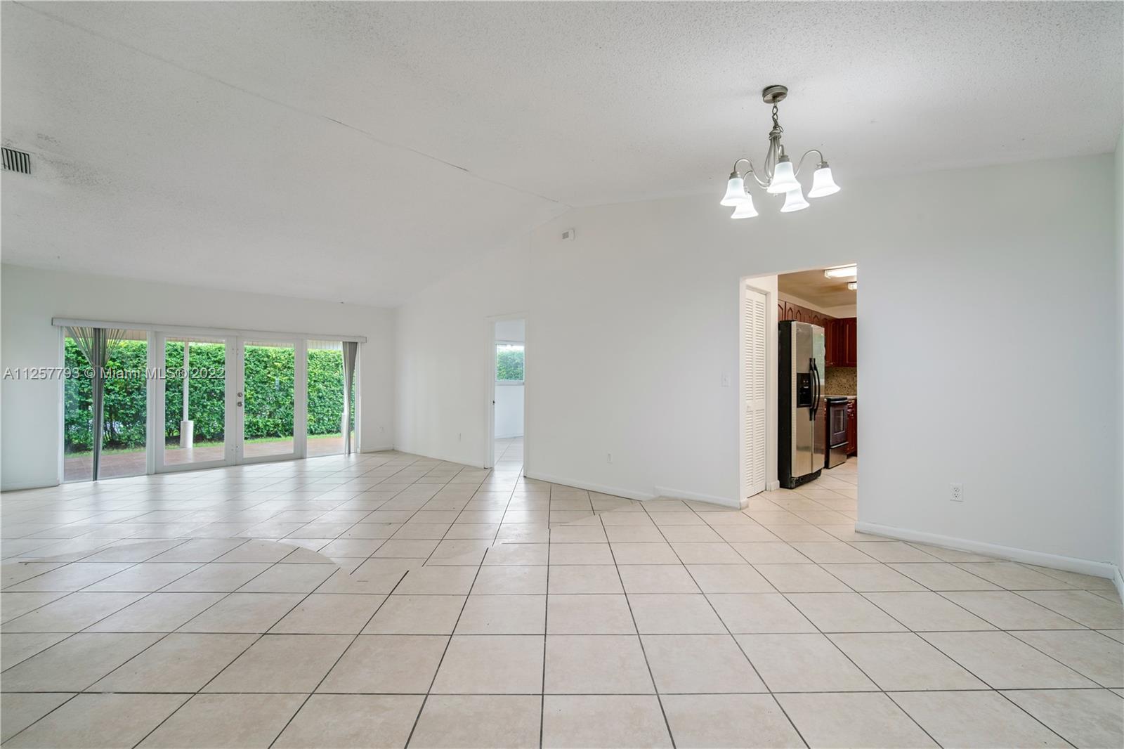 14121 Southwest 47th Street Miami, FL 33175 - Photo 6 of 45 an empty room with windows and ceiling fan