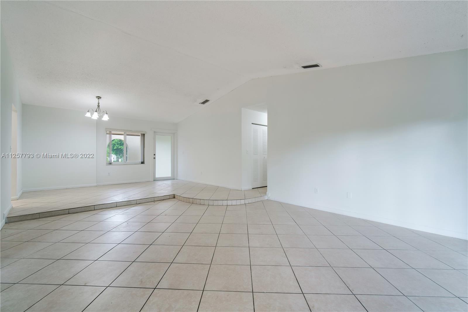 14121 Southwest 47th Street Miami, FL 33175 - Photo 8 of 45 an empty room with white walls and windows