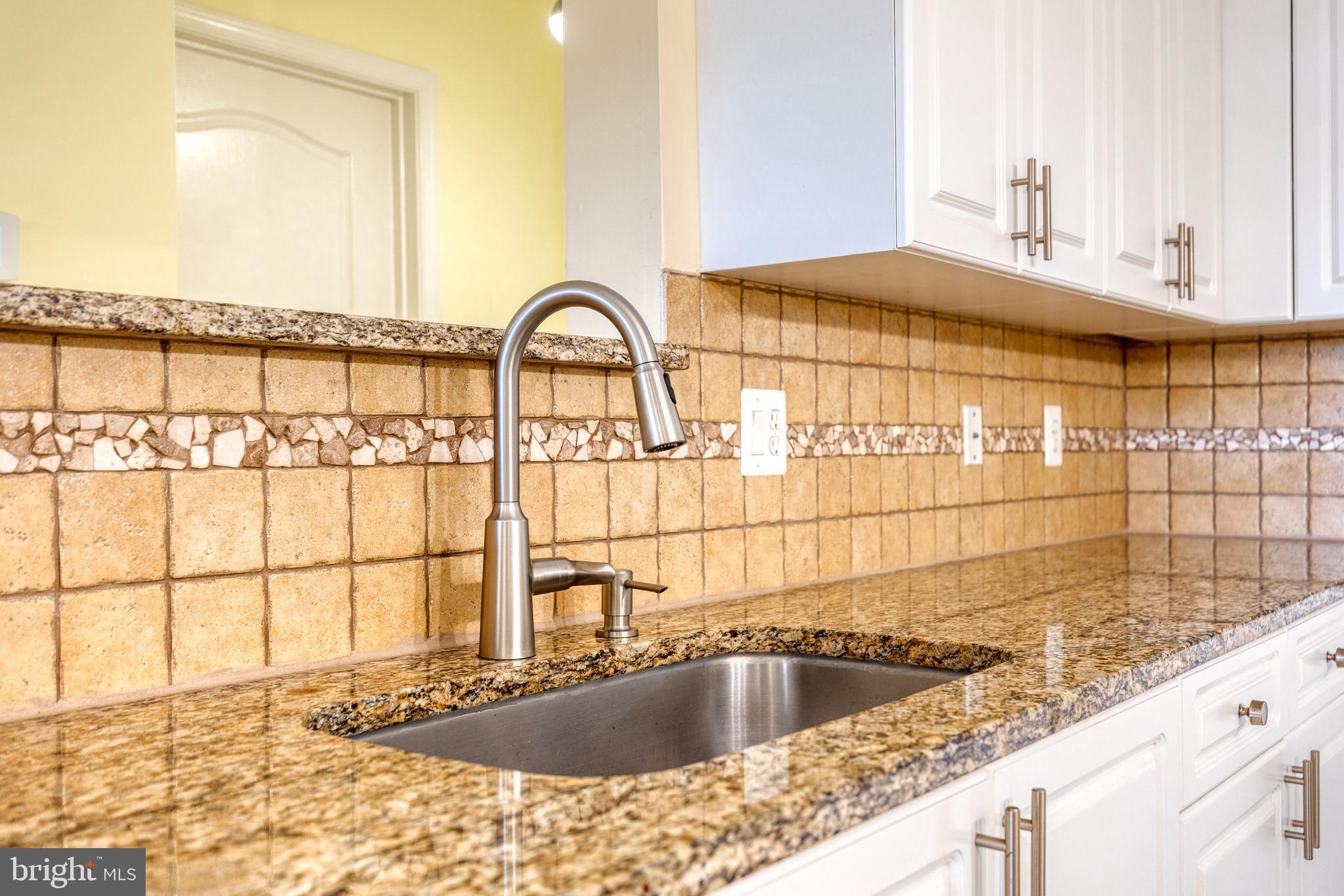 400 Symphony Circle, Unit 406 Hunt Valley, MD 21030 - Photo 13 of 37 a kitchen with a sink and a window