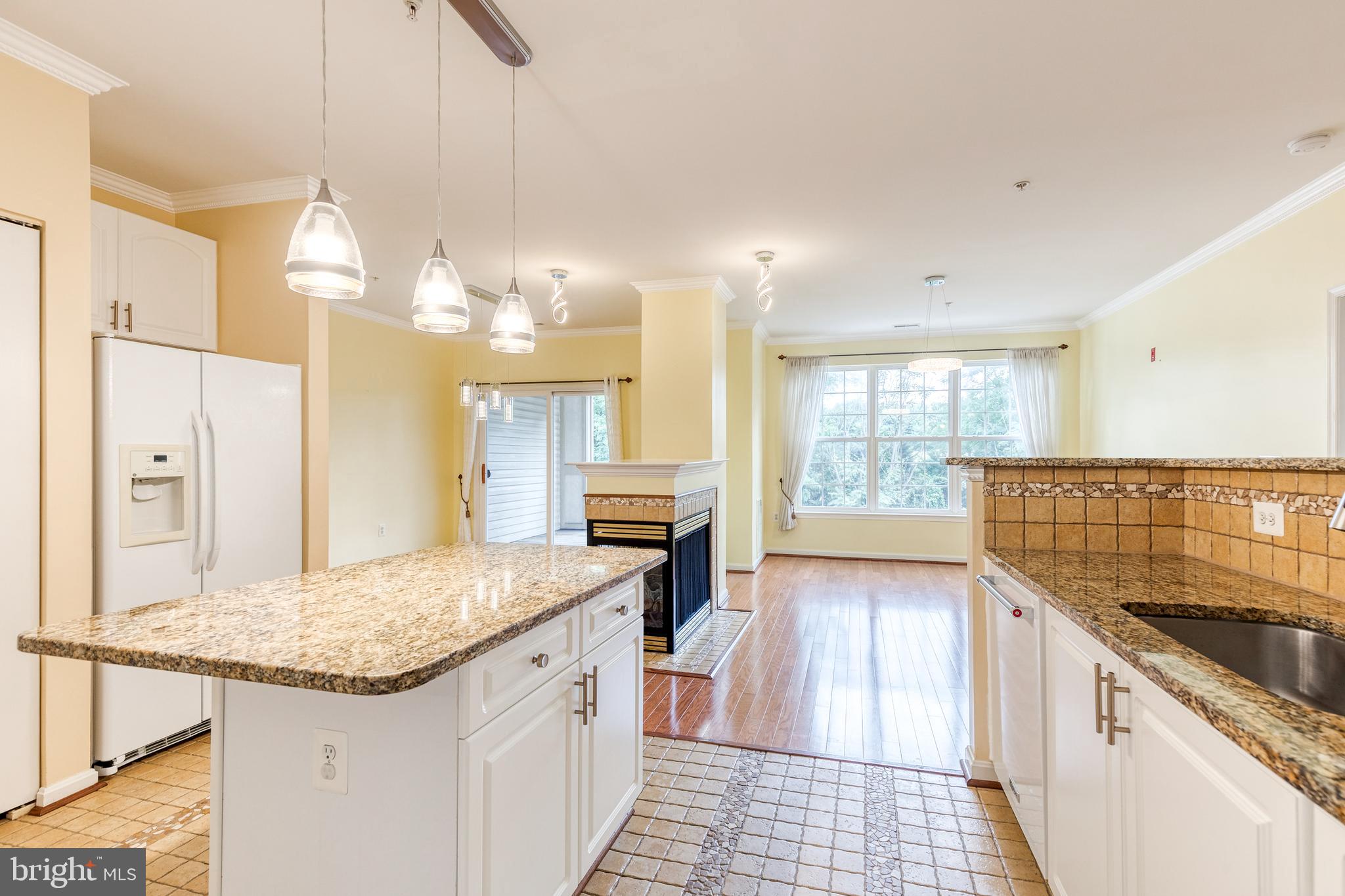 400 Symphony Circle, Unit 406 Hunt Valley, MD 21030 - Photo 15 of 37 a kitchen with stainless steel appliances granite countertop a sink and cabinets
