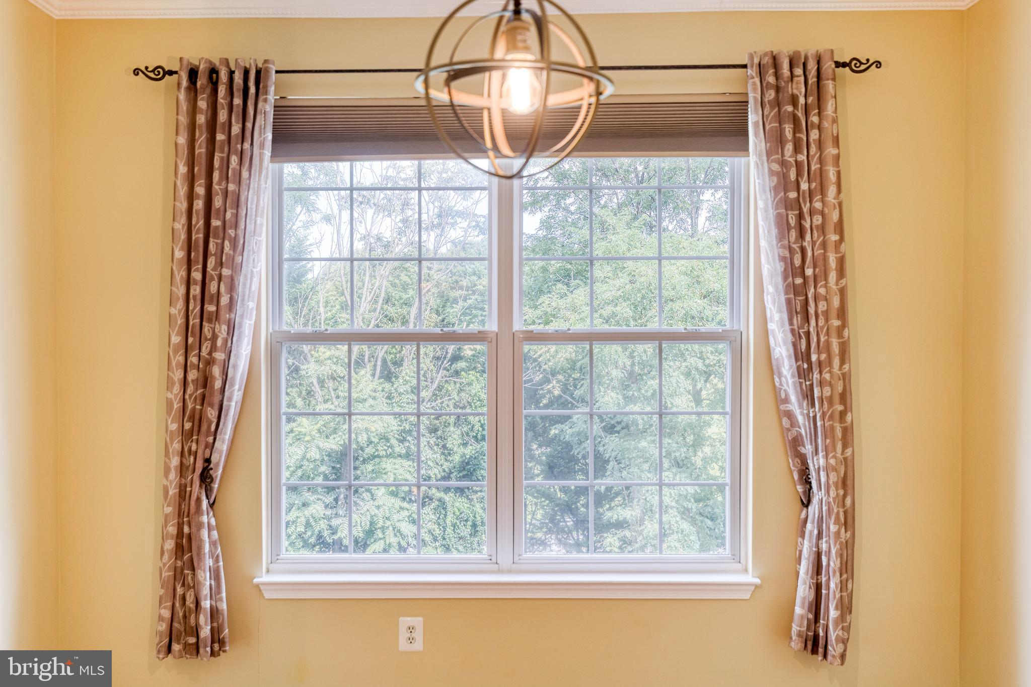 400 Symphony Circle, Unit 406 Hunt Valley, MD 21030 - Photo 23 of 37 a front view of a house with a big yard and chandelier