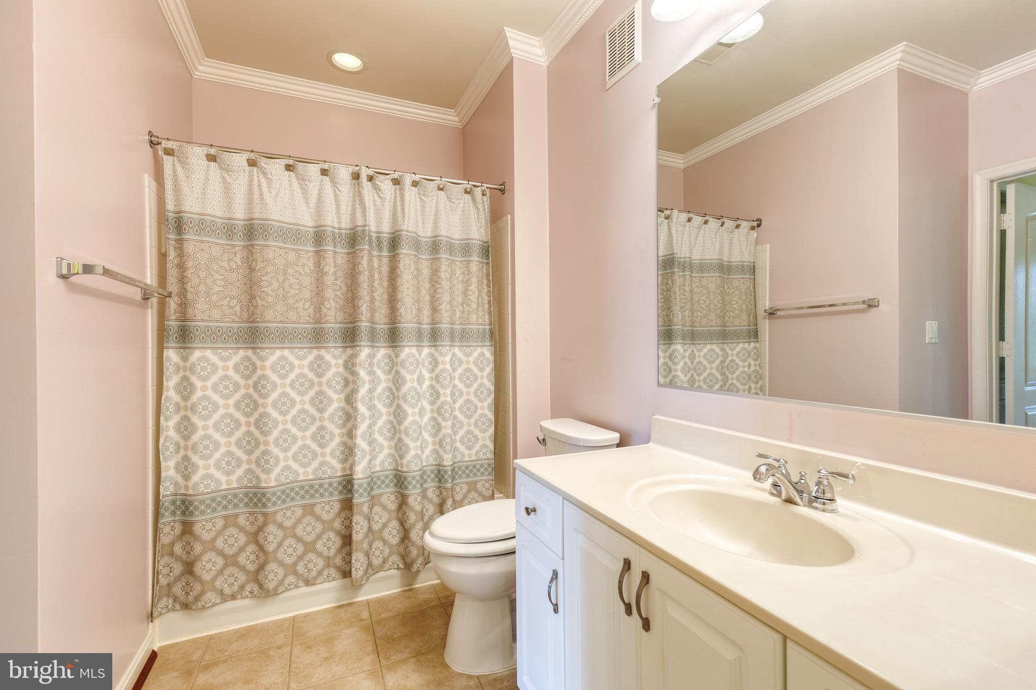 400 Symphony Circle, Unit 406 Hunt Valley, MD 21030 - Photo 24 of 37 a bathroom with a granite countertop sink toilet and shower