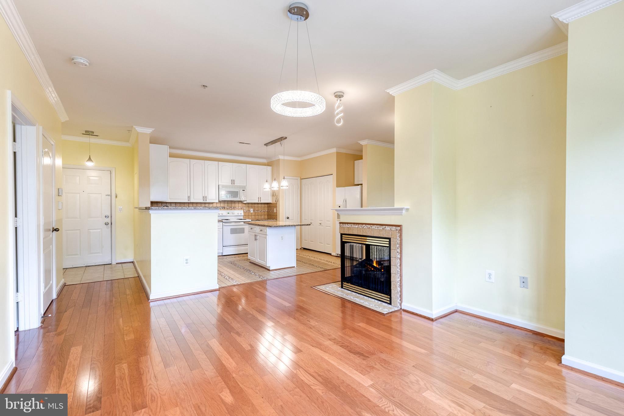 400 Symphony Circle, Unit 406 Hunt Valley, MD 21030 - Photo 3 of 37 a view of a kitchen with a sink cabinets and a fireplace