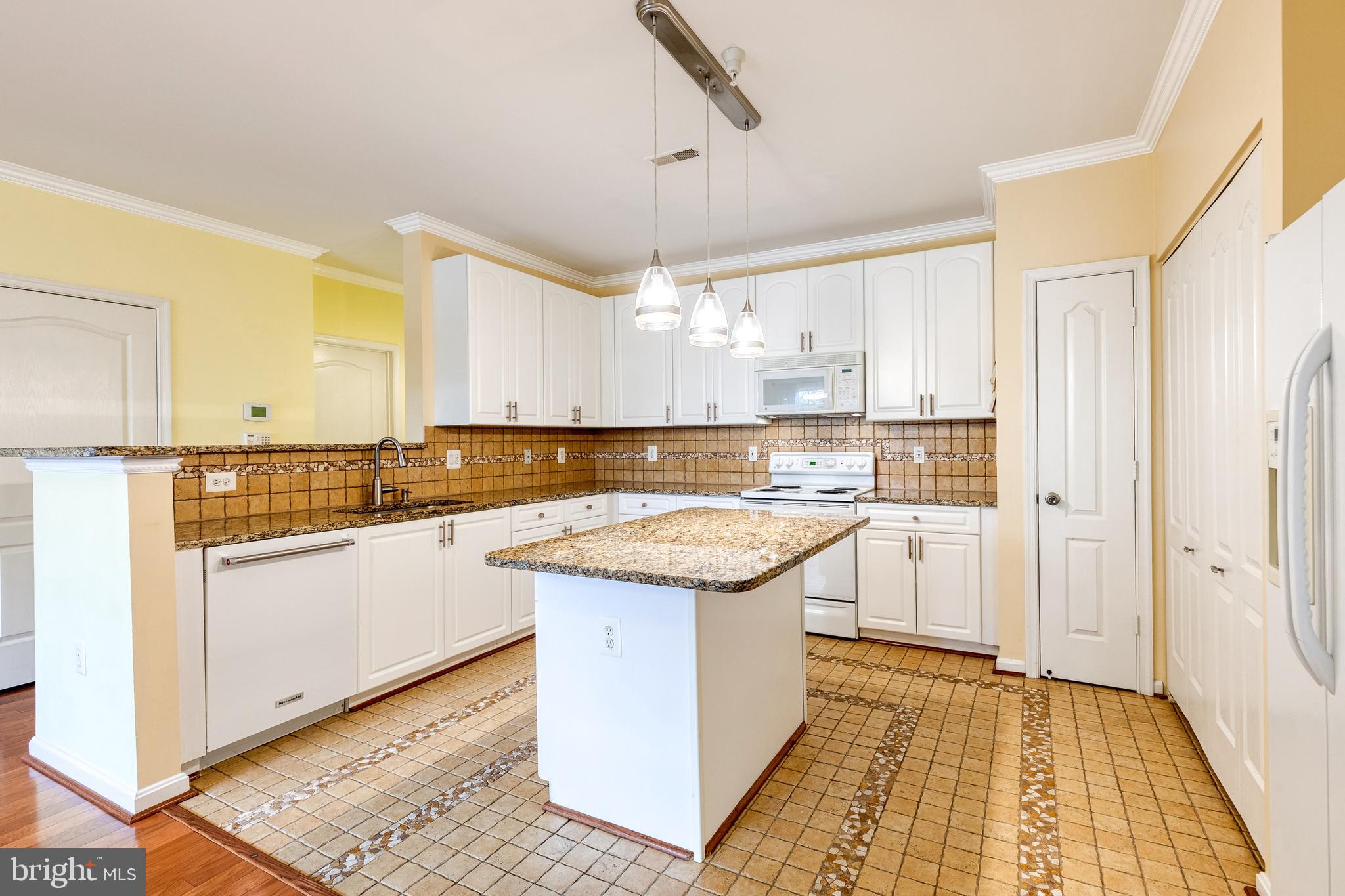 400 Symphony Circle, Unit 406 Hunt Valley, MD 21030 - Photo 10 of 37 a kitchen with stainless steel appliances granite countertop a sink and cabinets
