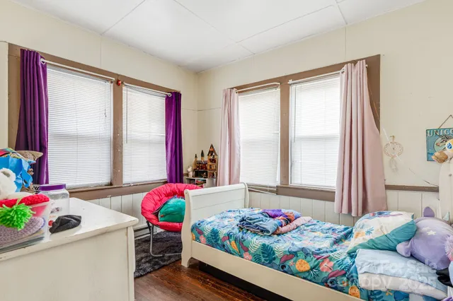 a bedroom with furniture and a potted plant