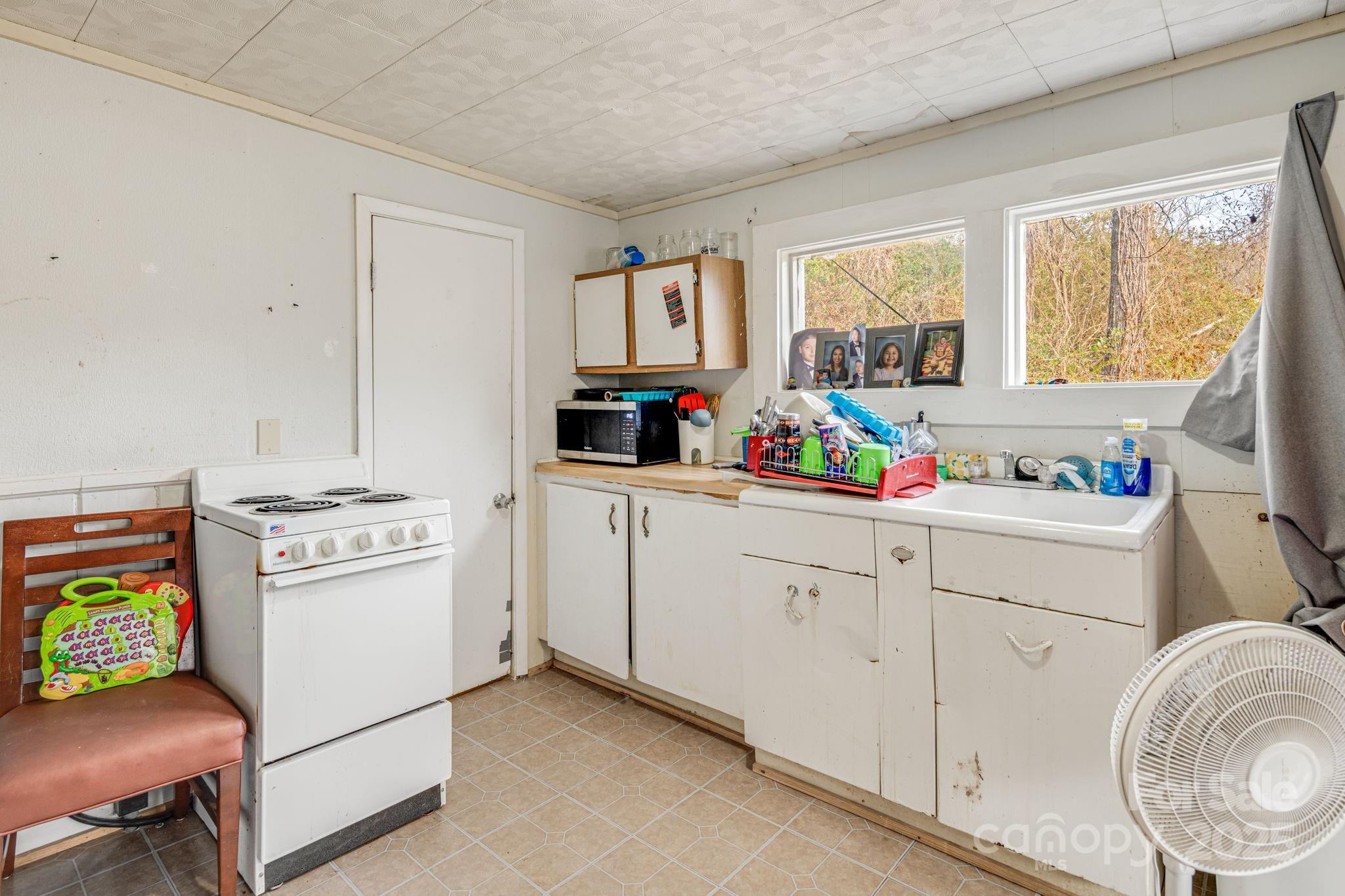 5454 Ela Road Whittier, NC 28789 - Photo 24 of 41 a kitchen with cabinets appliances and a open window