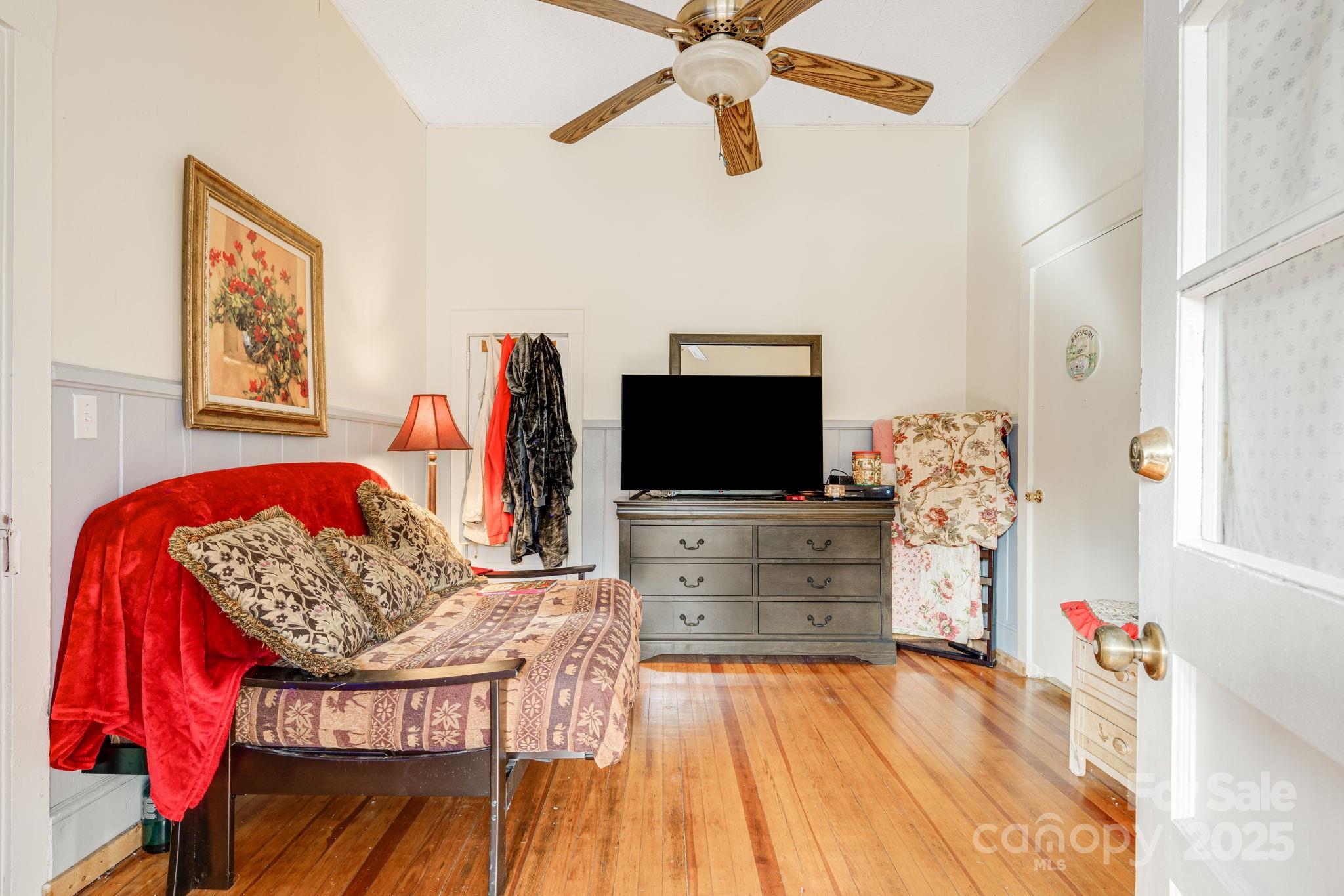 5454 Ela Road Whittier, NC 28789 - Photo 28 of 41 a bedroom with furniture and a flat screen tv