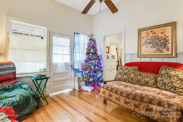 a living room with furniture and flowers