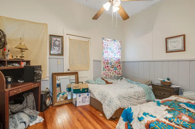 a bedroom that has a bed and a chair in it