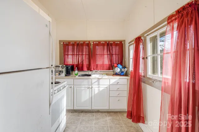 a kitchen with stainless steel appliances granite countertop a sink and a refrigerator