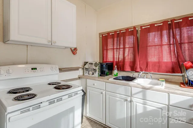 a kitchen with a white cabinets and white appliances