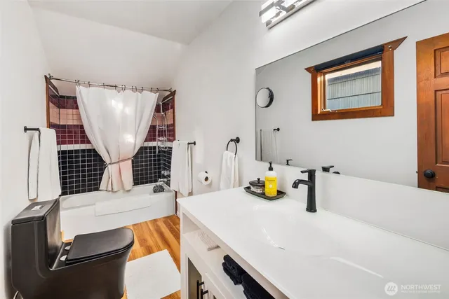 a bedroom with a bed and a television