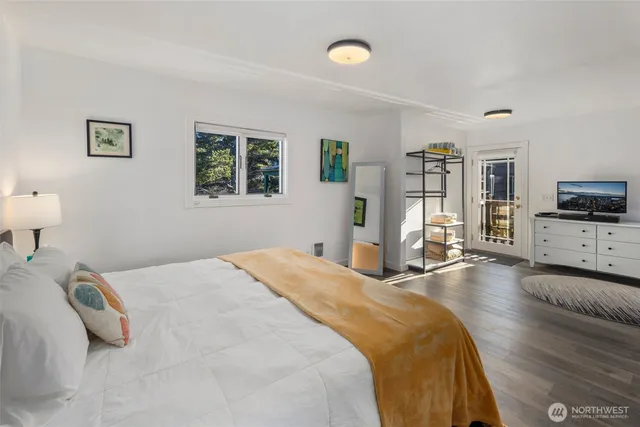 a bedroom with a bed and a painting on the wall