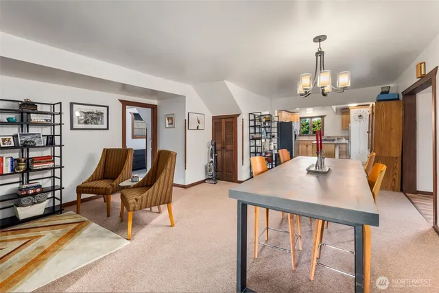 a living room with furniture a dining table and chairs with wooden floor