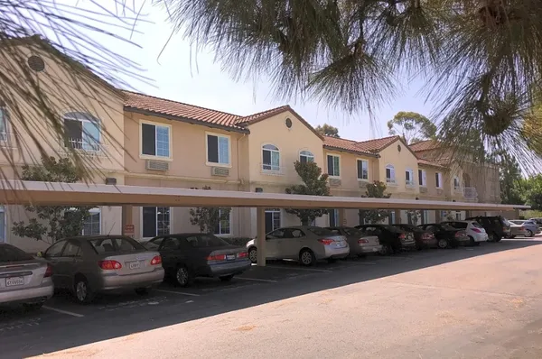 a view of a car park in front of house