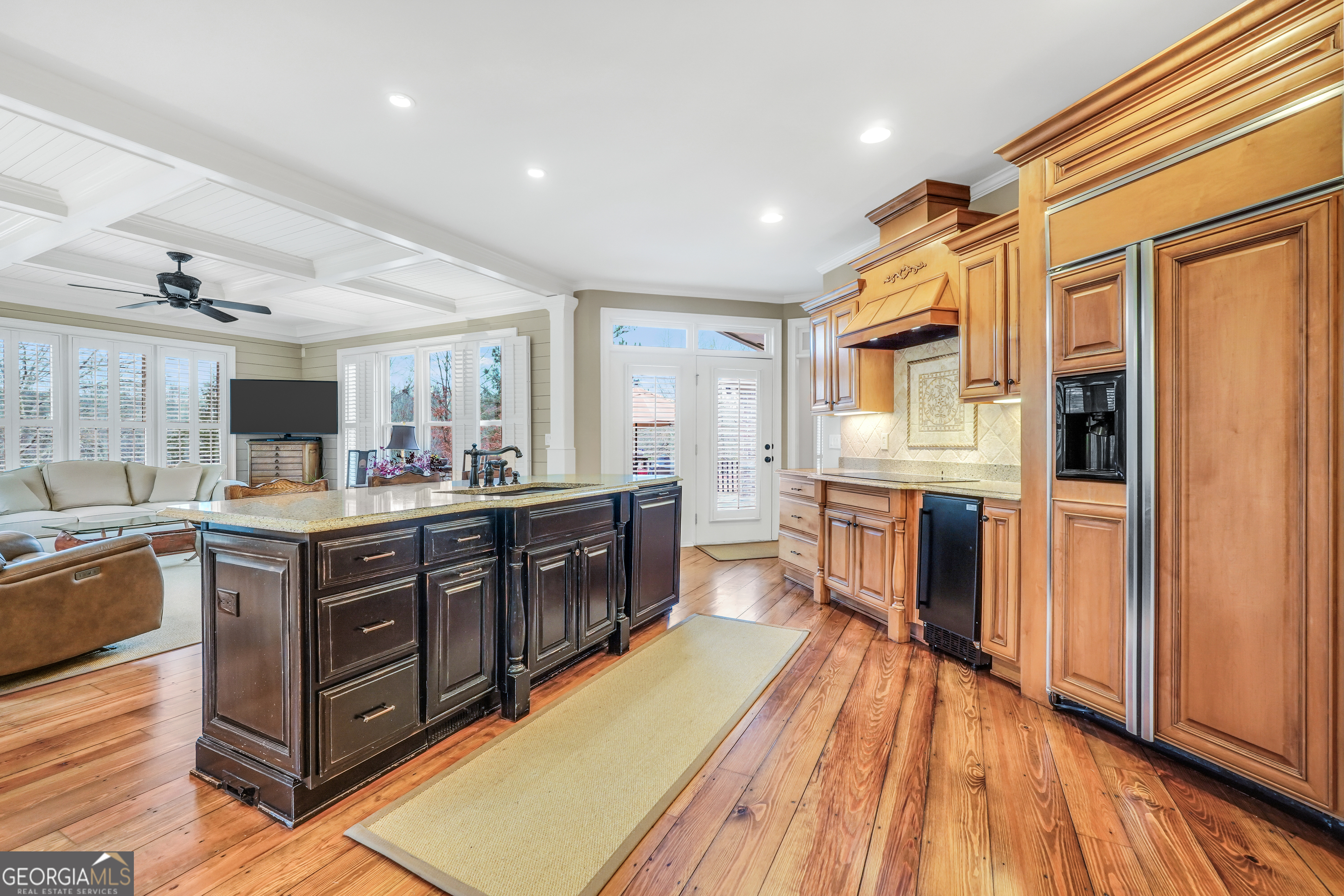 610 Elliott Road McDonough, GA 30252 - Photo 18 of 92 a kitchen with stainless steel appliances granite countertop a refrigerator a sink dishwasher a dining table and chairs with wooden floor