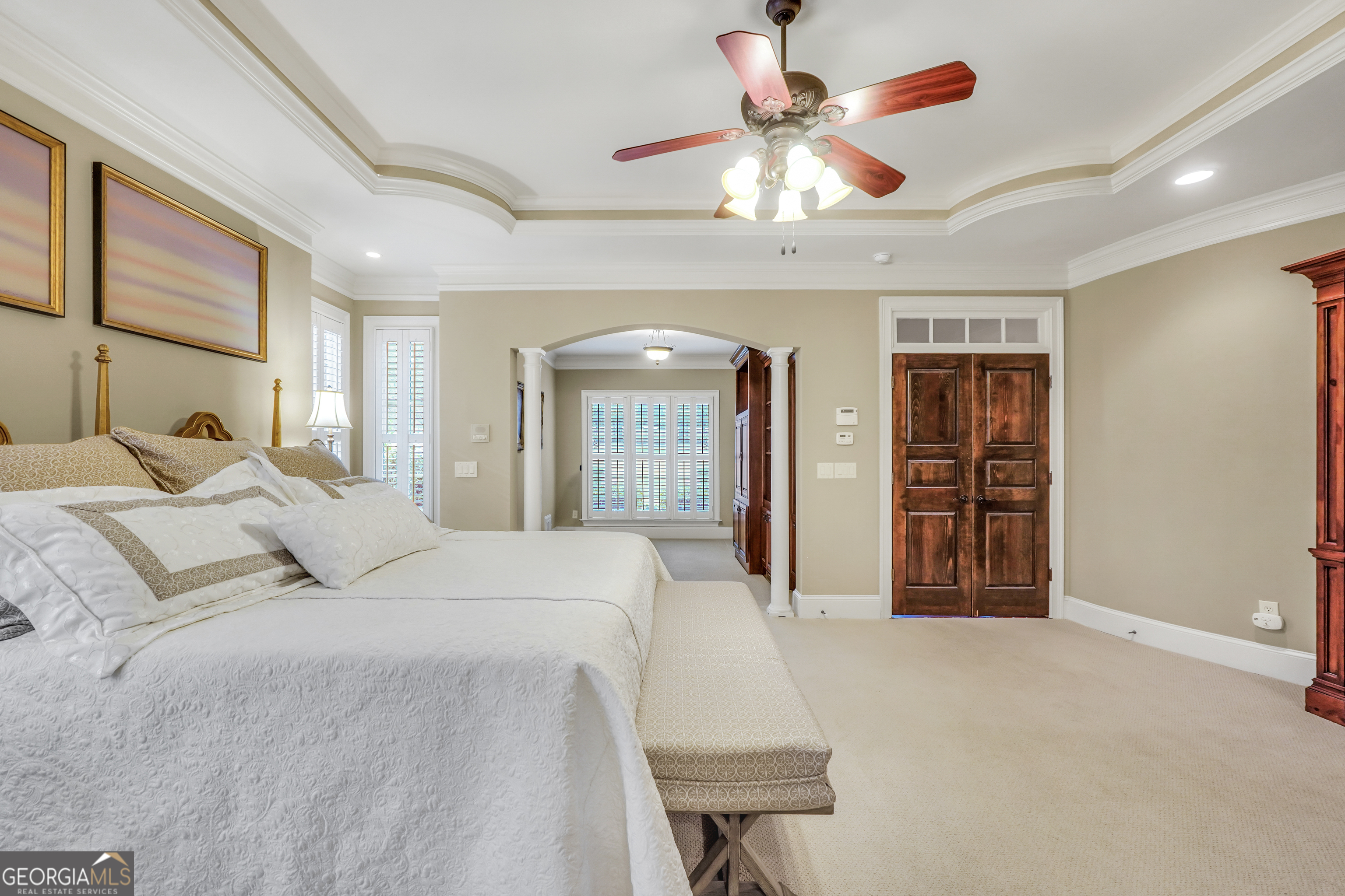 610 Elliott Road McDonough, GA 30252 - Photo 33 of 92 a bedroom with a large bed and a chandelier