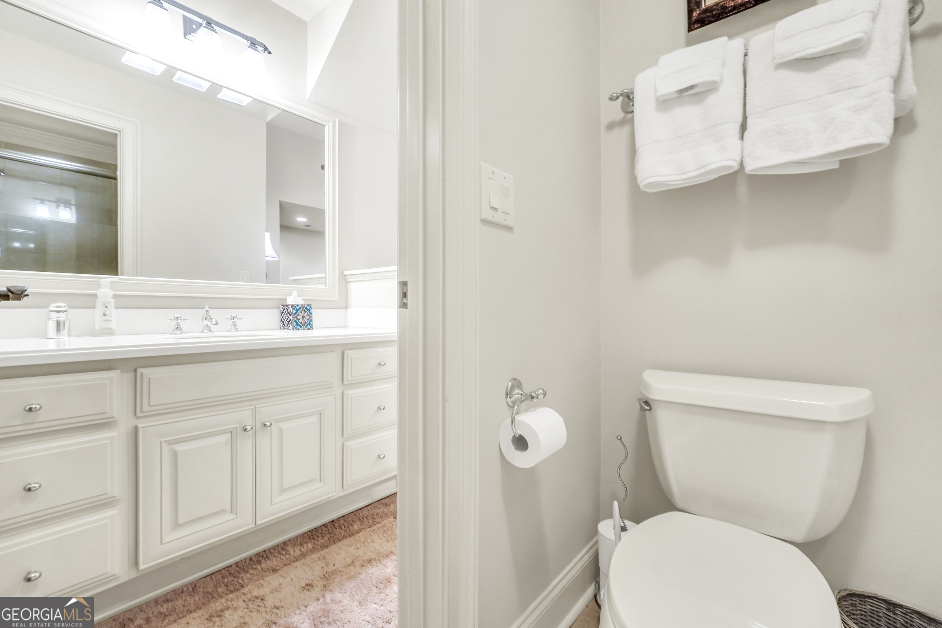 610 Elliott Road McDonough, GA 30252 - Photo 49 of 92 a bathroom with a granite countertop toilet sink and mirror
