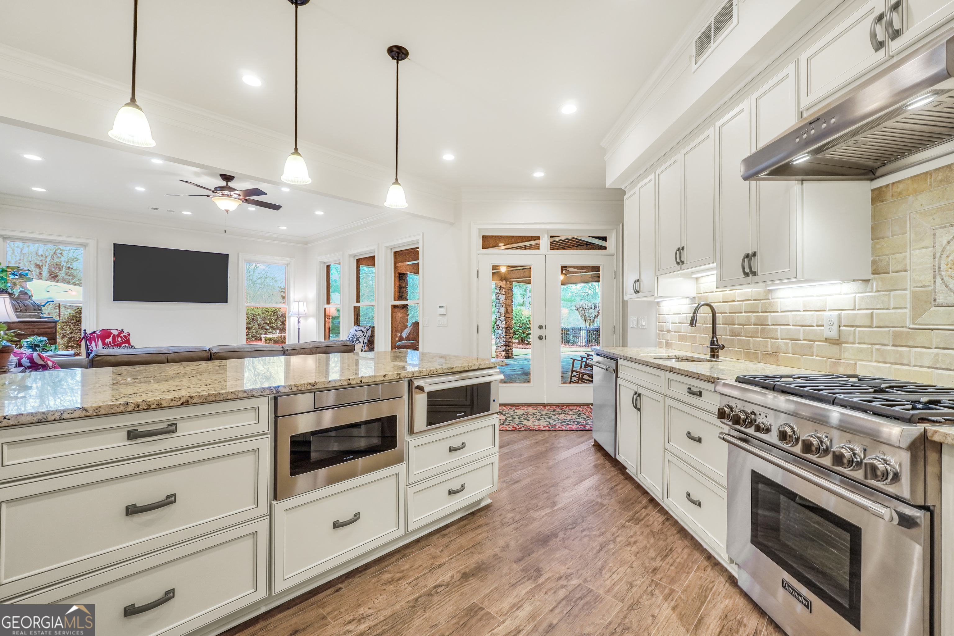 610 Elliott Road McDonough, GA 30252 - Photo 58 of 92 a large kitchen with stainless steel appliances kitchen island granite countertop a stove and a view of living room