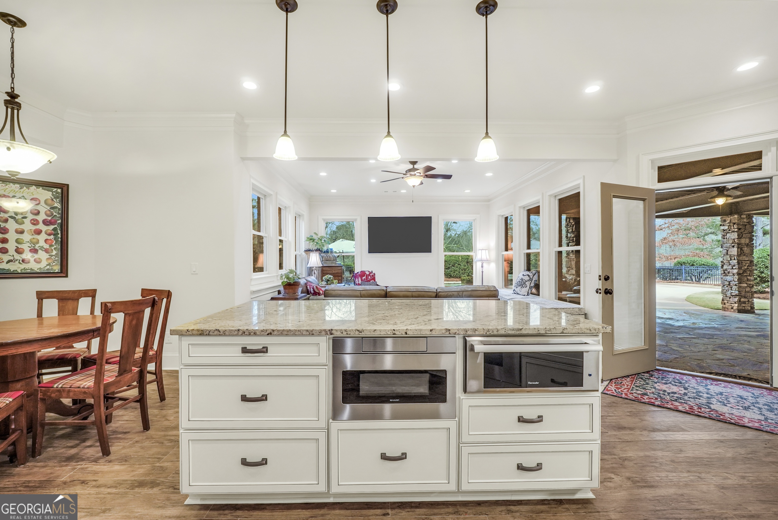 610 Elliott Road McDonough, GA 30252 - Photo 60 of 92 a kitchen with stainless steel appliances kitchen island granite countertop a table and chairs in it