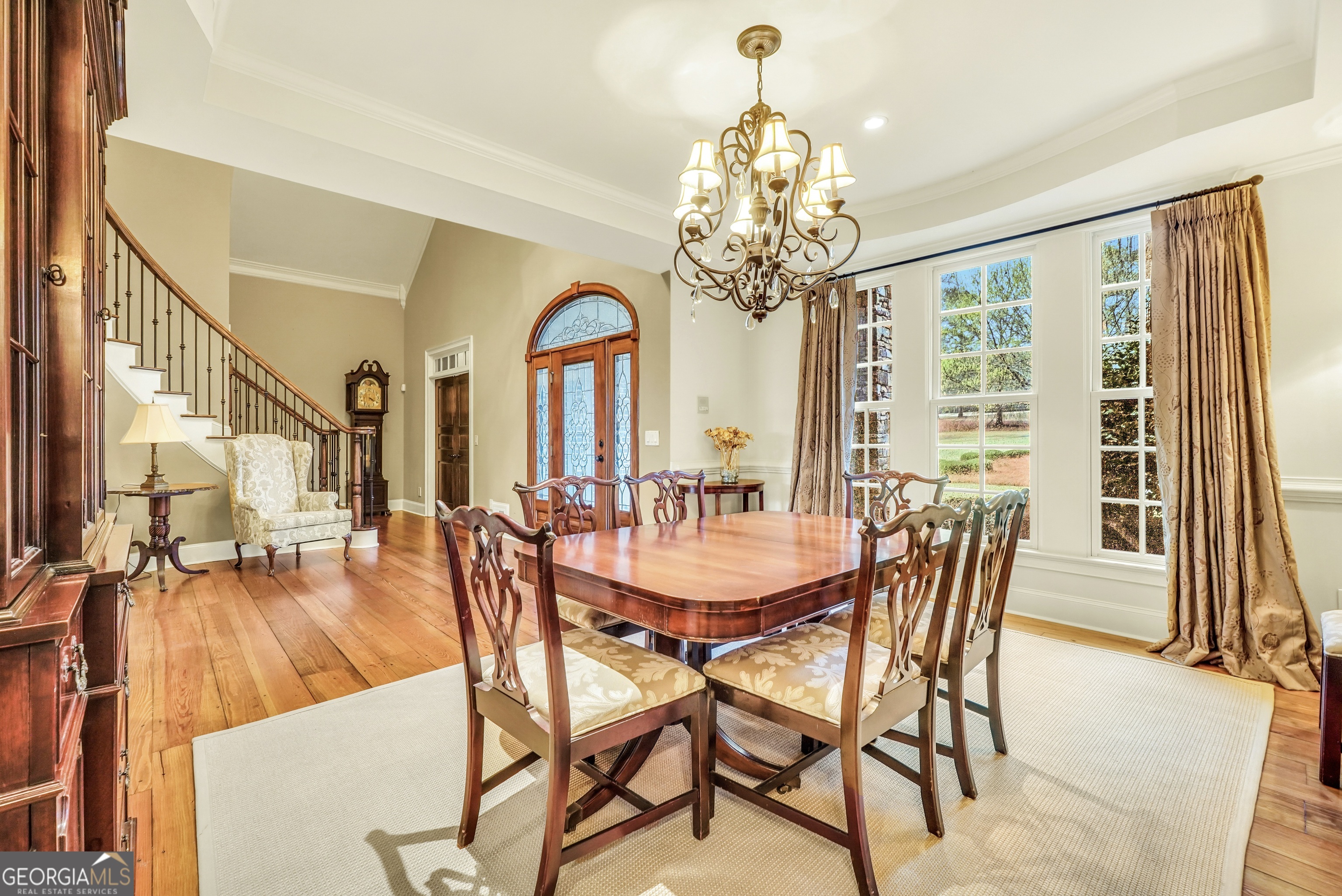 610 Elliott Road McDonough, GA 30252 - Photo 8 of 92 a view of a dining room with furniture a chandelier and wooden floor