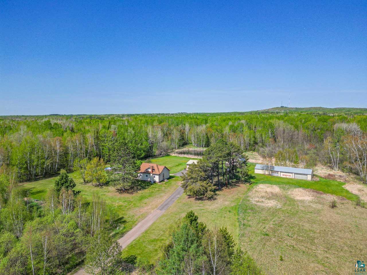 2581 O'Rourke Road Hibbing, MN 55746 - Photo 59 of 61 Rural property with a single-story residence, a long gravel driveway, and a large outbuilding