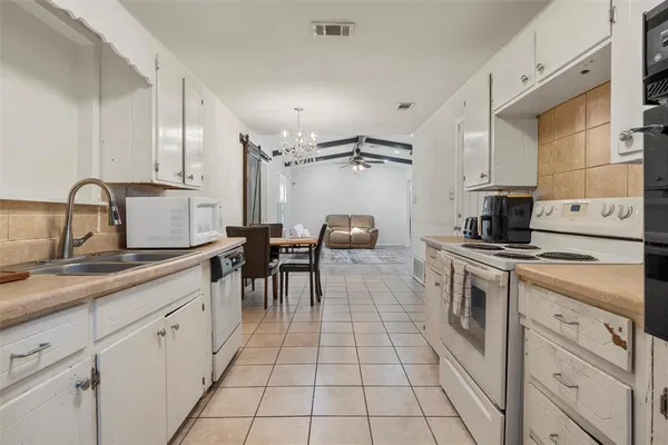 a kitchen with a sink cabinets and appliances