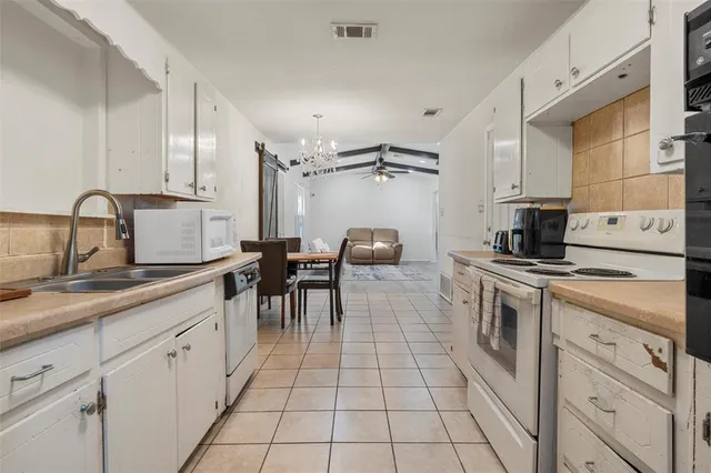 a kitchen with a sink cabinets and appliances