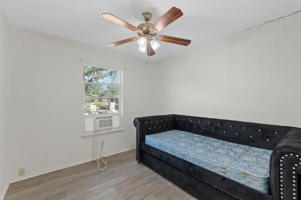 a bedroom with bed and window