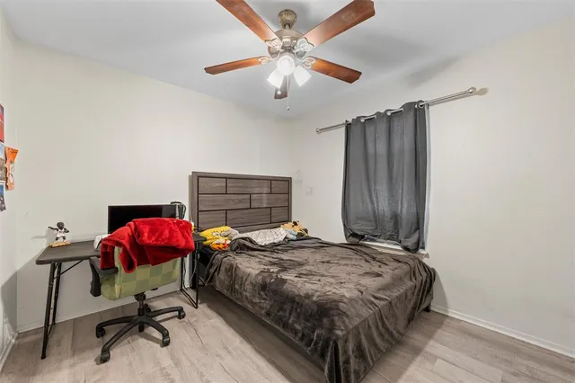 a bedroom with a bed and a chandelier