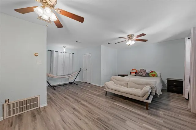 a bedroom with furniture and wooden floor