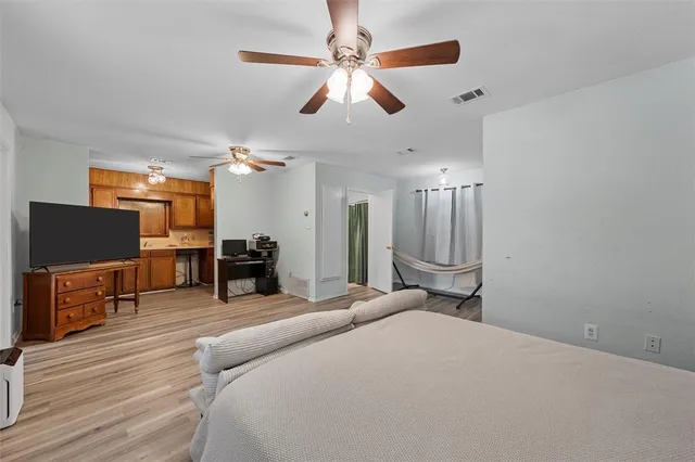 a bed room with a bed and a television