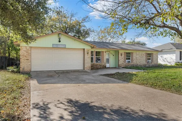 a view of a house with a yard and garage