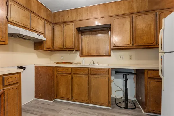 a kitchen with stainless steel appliances granite countertop a sink and wooden cabinets