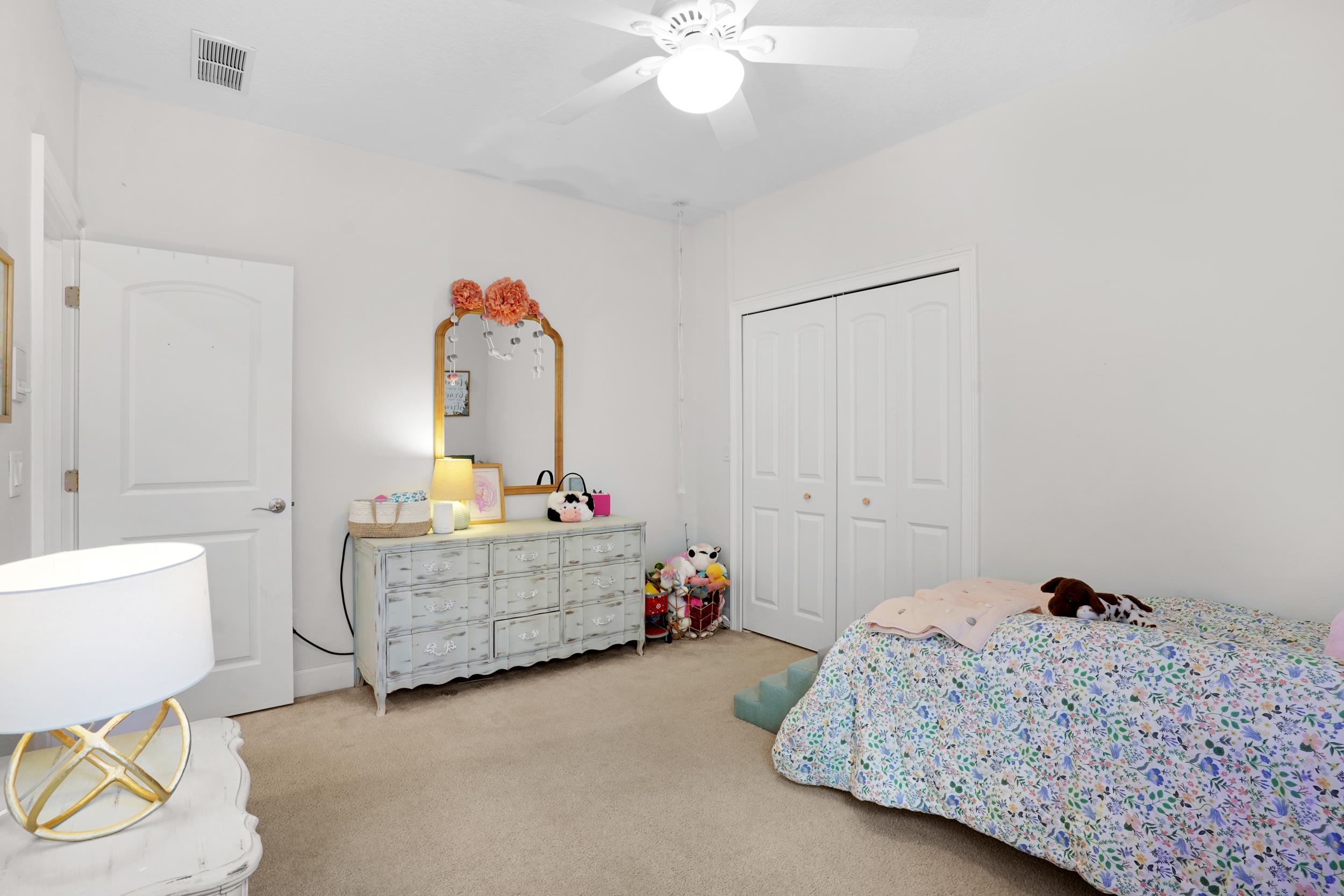 1308 Acorn Ridge Court St. Augustine, FL 32092 - Photo 34 of 47 a bedroom with a bed and a chandelier