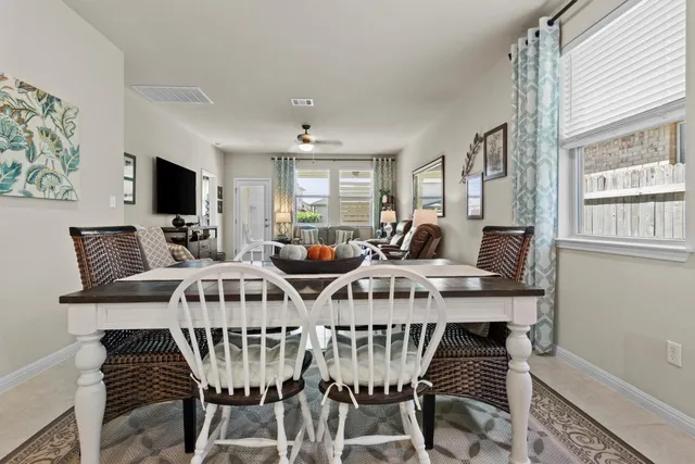 a utility room with lots of clutter and cabinets
