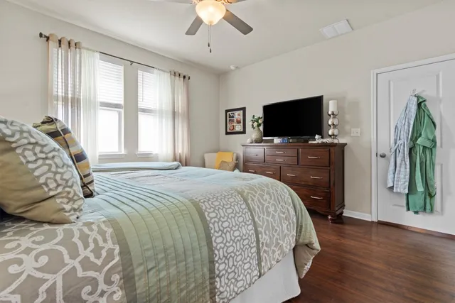 a bedroom with a bed and a chandelier
