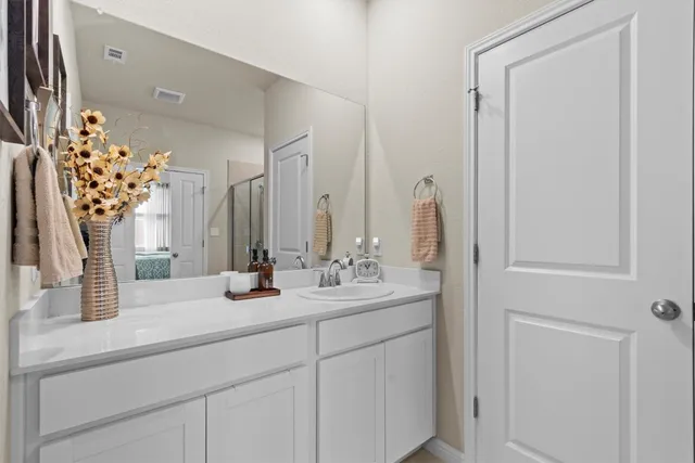 a spacious bathroom with a shower and a sink