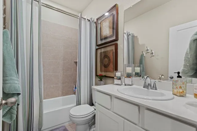 a bedroom with a bed a mirror and night stand