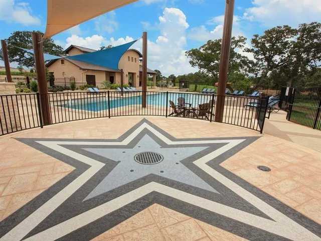 a view of a patio with table and chairs with wooden floor and fence