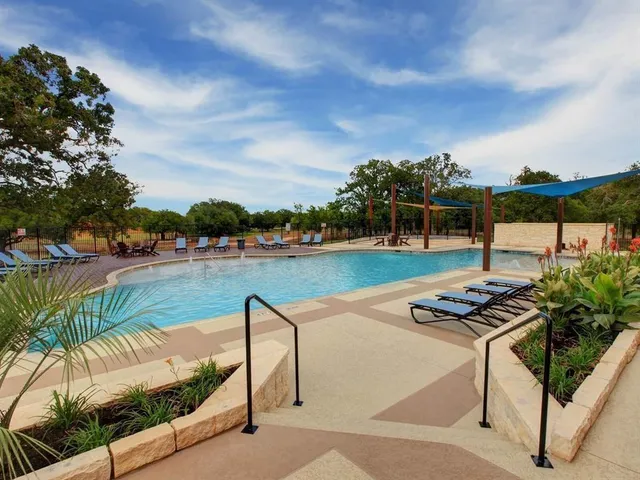 a view of swimming pool with outdoor seating and plants