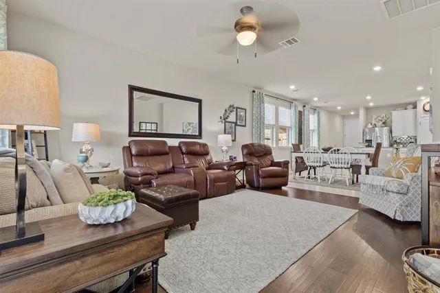 a living room with furniture and wooden floor