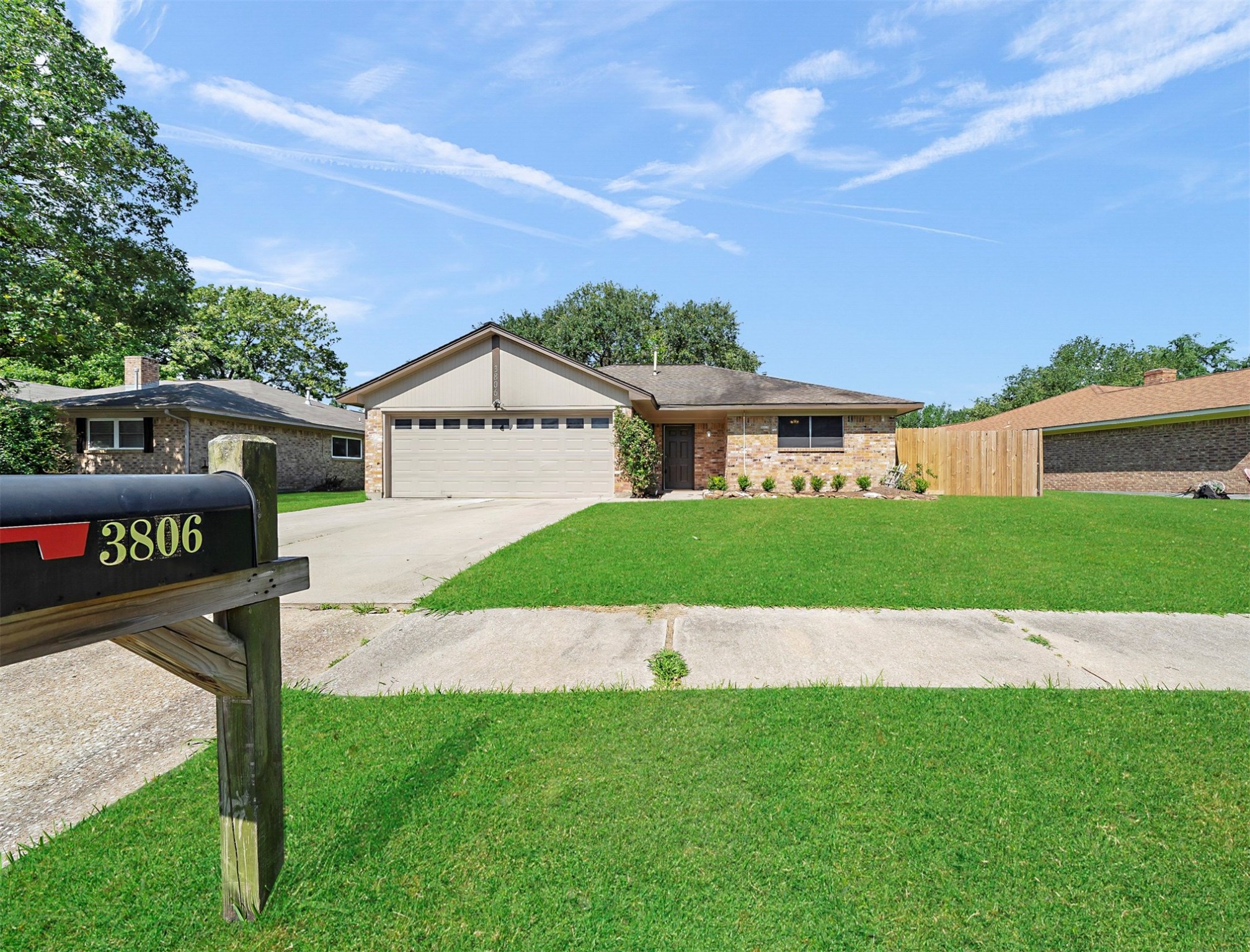 a view of an house with backyard space and a tree