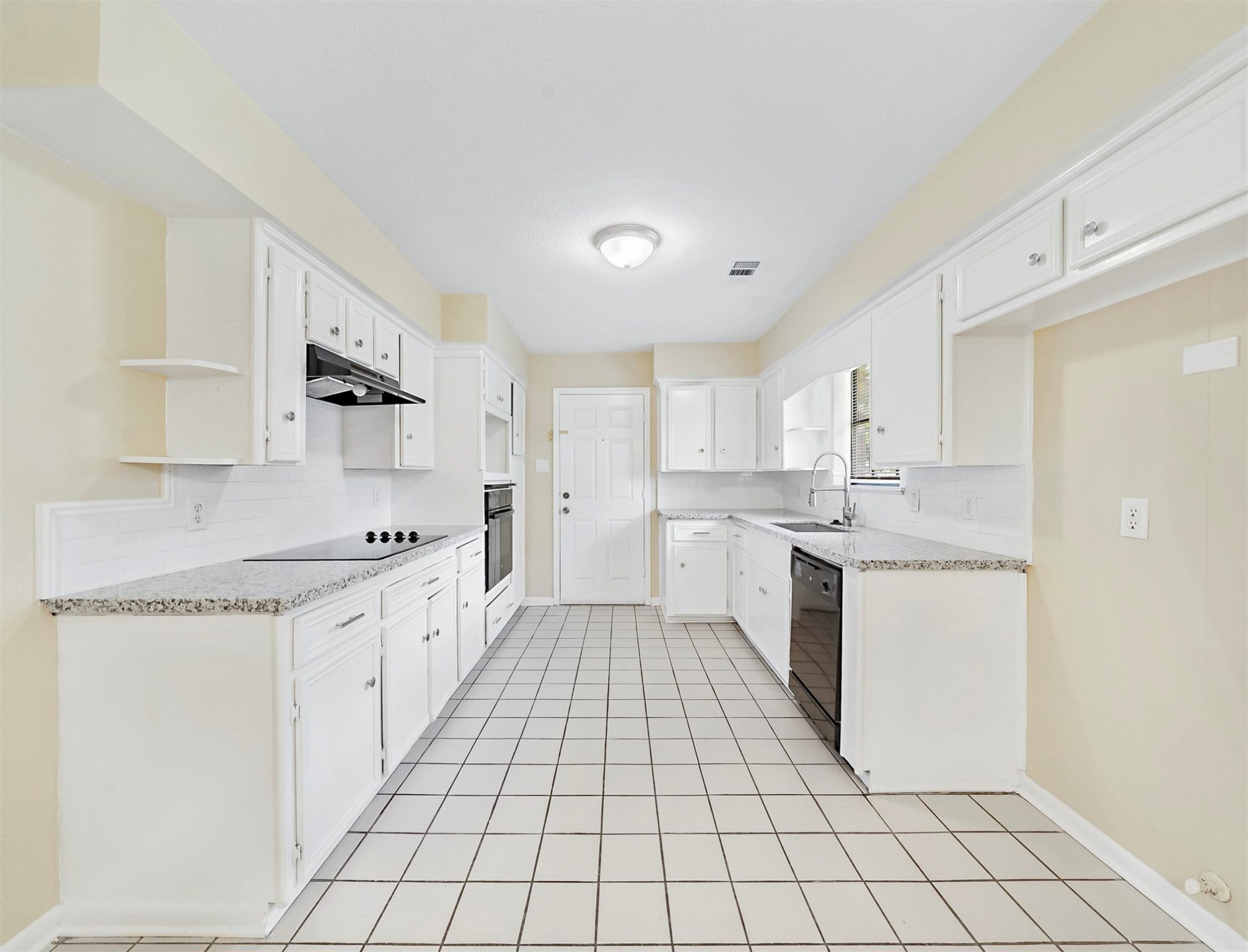 3806 Montego Drive Baytown, TX 77521 - Photo 13 of 19 a large white kitchen with a sink a stove top oven and white cabinets