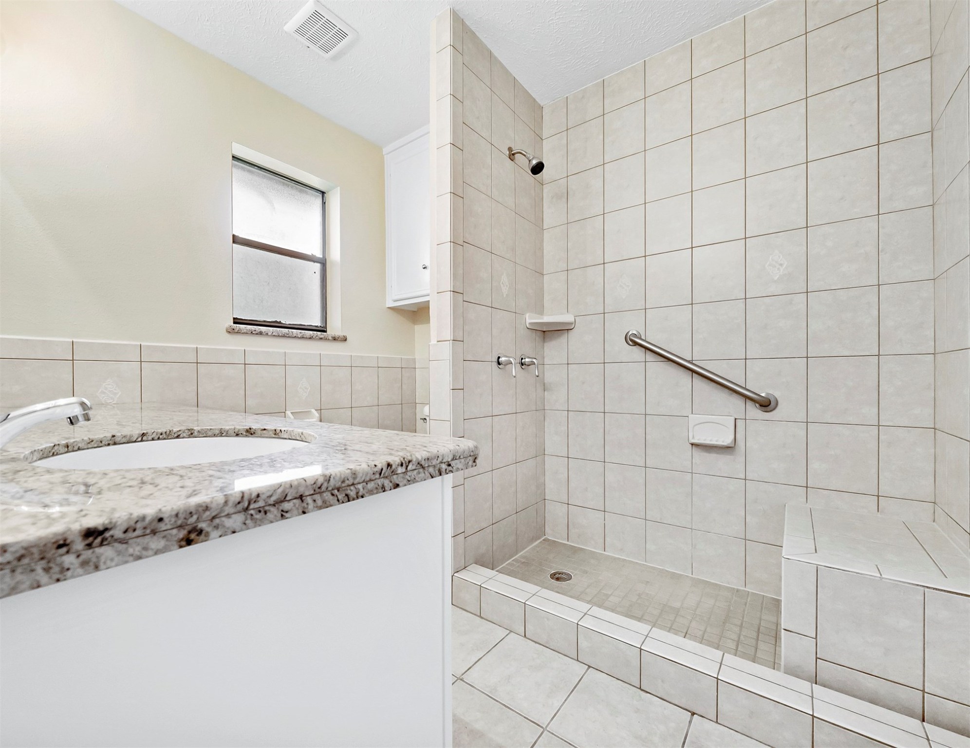 3806 Montego Drive Baytown, TX 77521 - Photo 18 of 19 a bathroom with a granite countertop sink a toilet and shower