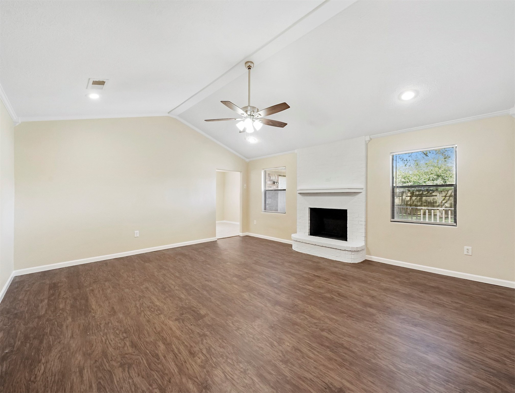 3806 Montego Drive Baytown, TX 77521 - Photo 10 of 19 an empty room with windows and fireplace