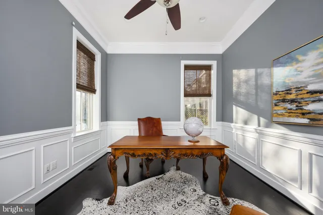 a living room with furniture a fireplace and a large window