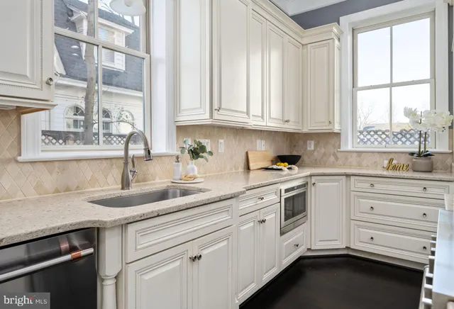 a spacious bathroom with a granite countertop sink and a mirror