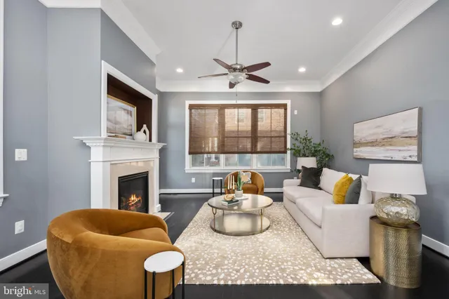 a bathroom with a granite countertop sink a toilet a mirror and window
