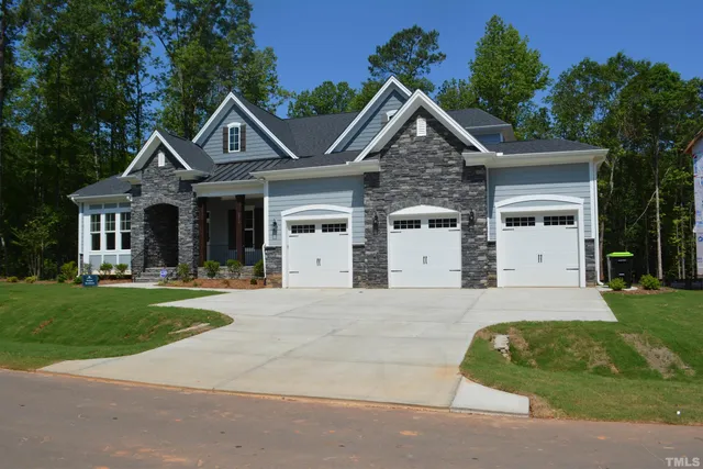 an entryway with wooden floor and windows